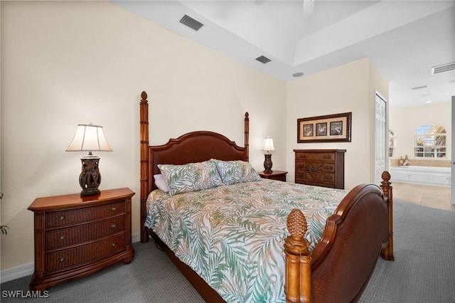 carpeted bedroom with ceiling fan and ensuite bathroom