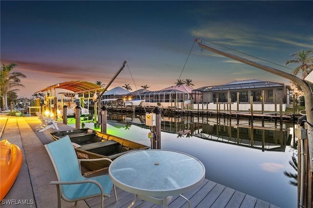 dock area featuring glass enclosure and a water view