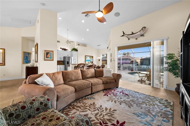 tiled living room featuring ceiling fan and high vaulted ceiling