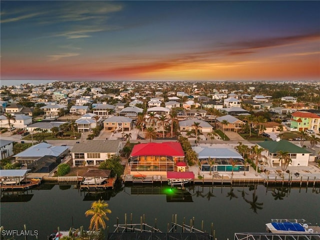 aerial view at dusk with a water view