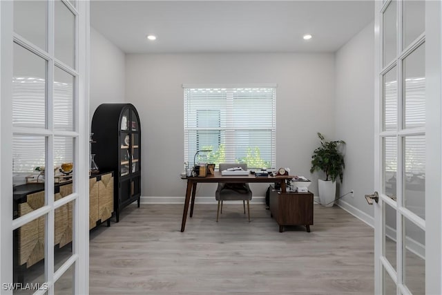 office featuring light hardwood / wood-style flooring and french doors