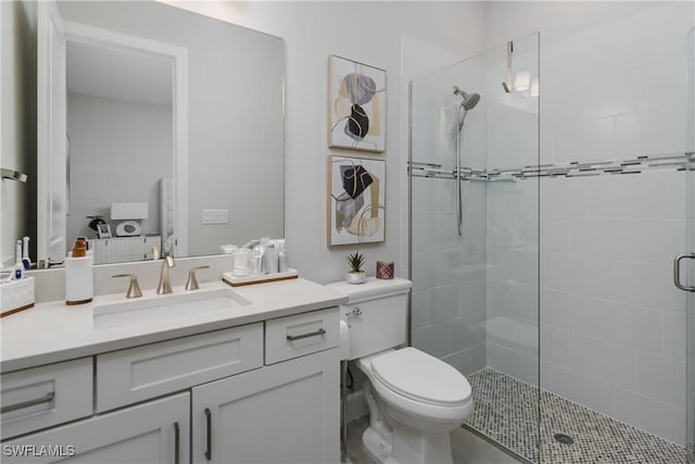 bathroom featuring walk in shower, vanity, and toilet