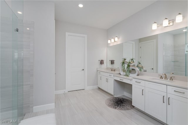 bathroom featuring vanity and an enclosed shower