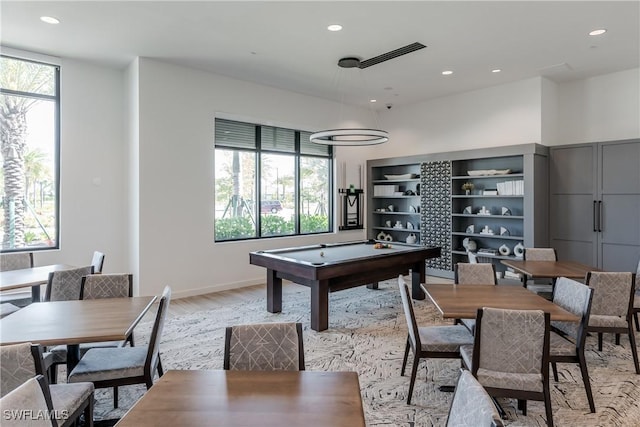 game room with light hardwood / wood-style floors and a healthy amount of sunlight