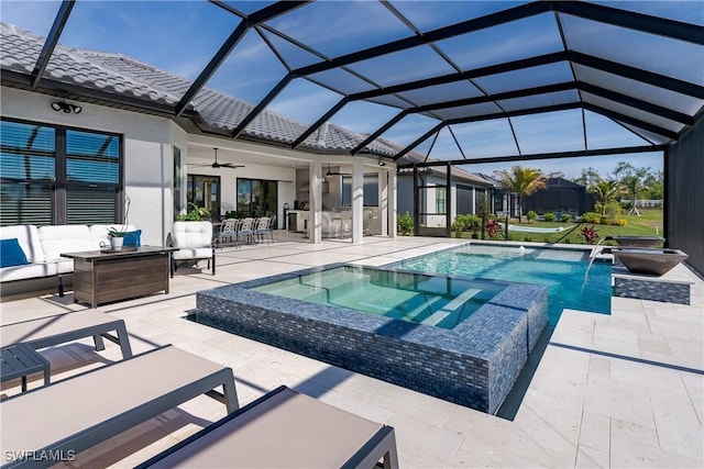 view of swimming pool with pool water feature, a patio area, a lanai, an in ground hot tub, and an outdoor living space