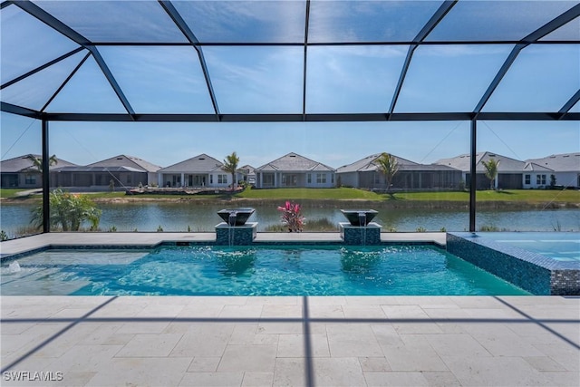 view of pool featuring an in ground hot tub, a water view, pool water feature, and glass enclosure