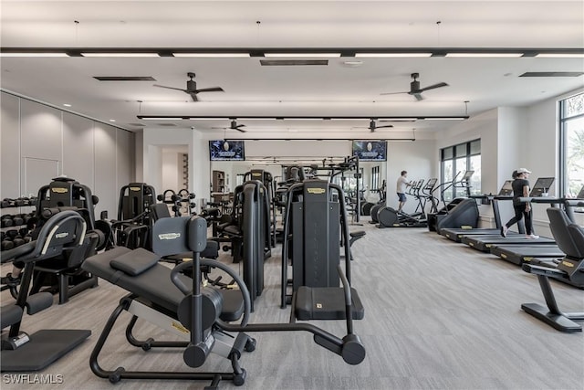 exercise room with light carpet and ceiling fan