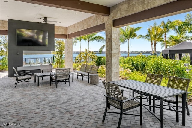 view of patio / terrace featuring an outdoor hangout area, ceiling fan, and a water view