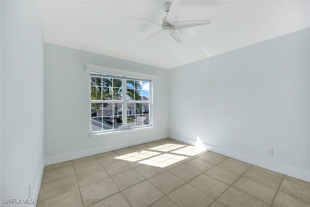 spare room with light tile patterned flooring and ceiling fan