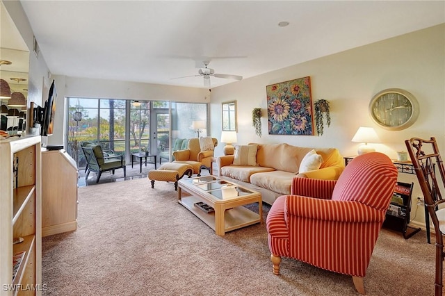 carpeted living room featuring french doors and ceiling fan