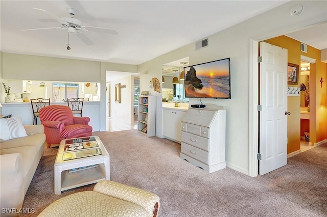 carpeted living room featuring ceiling fan