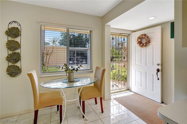 dining space with light tile patterned flooring and plenty of natural light