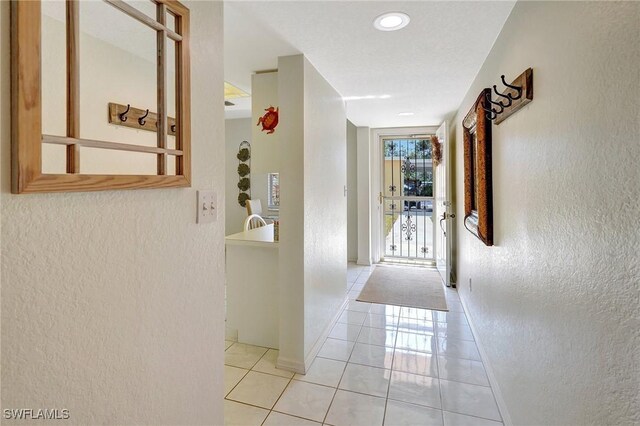 hallway featuring light tile patterned floors