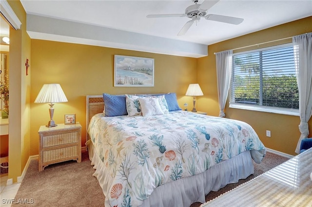 carpeted bedroom featuring ceiling fan and baseboards