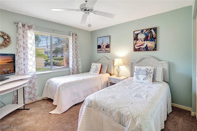 carpeted bedroom with a ceiling fan and baseboards