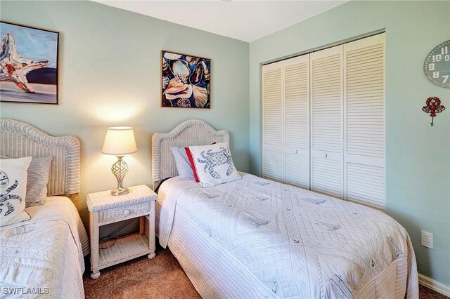 carpeted bedroom with a closet