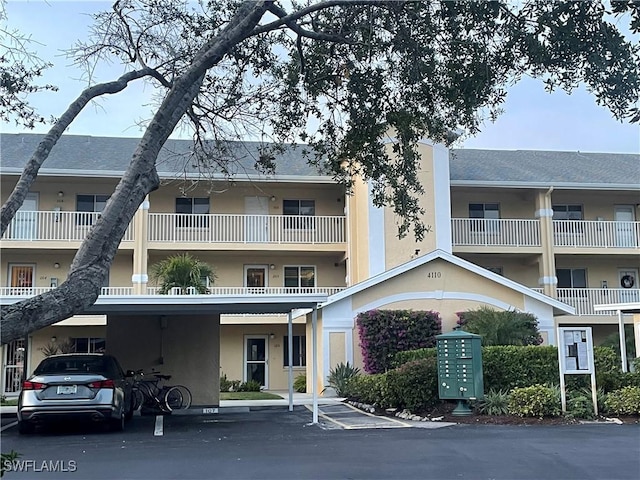 view of building exterior with covered parking