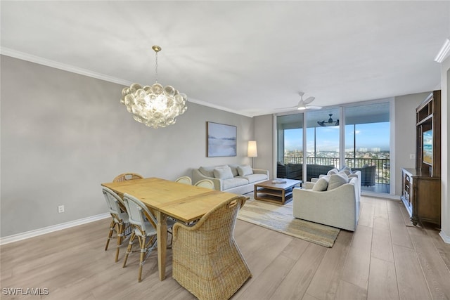 dining space featuring light wood-style floors, baseboards, expansive windows, and ornamental molding