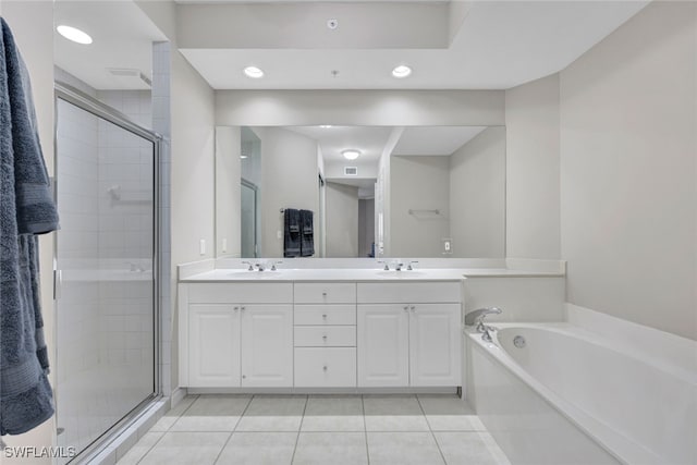 full bathroom featuring a garden tub, tile patterned flooring, a sink, double vanity, and a stall shower