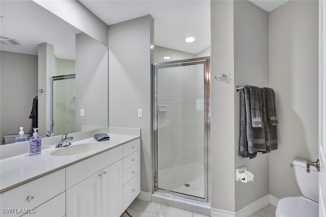 bathroom featuring visible vents, toilet, a stall shower, vanity, and baseboards