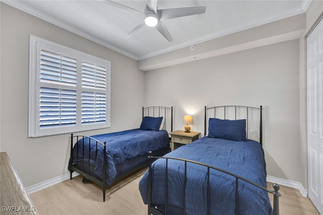 bedroom featuring crown molding, wood finished floors, a ceiling fan, and baseboards