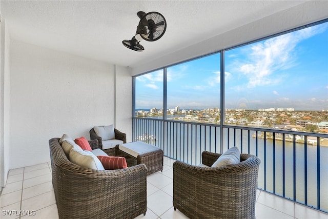 sunroom / solarium featuring a water view and a city view