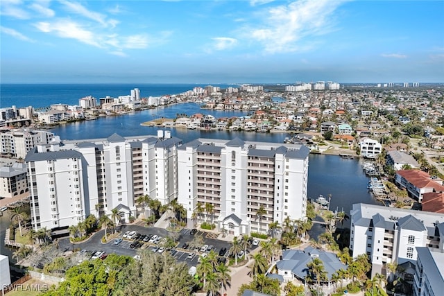 drone / aerial view featuring a view of city and a water view