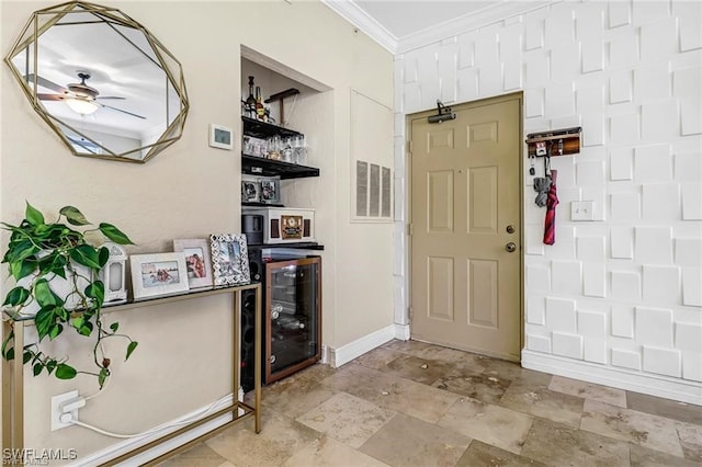 foyer with crown molding, bar area, and ceiling fan