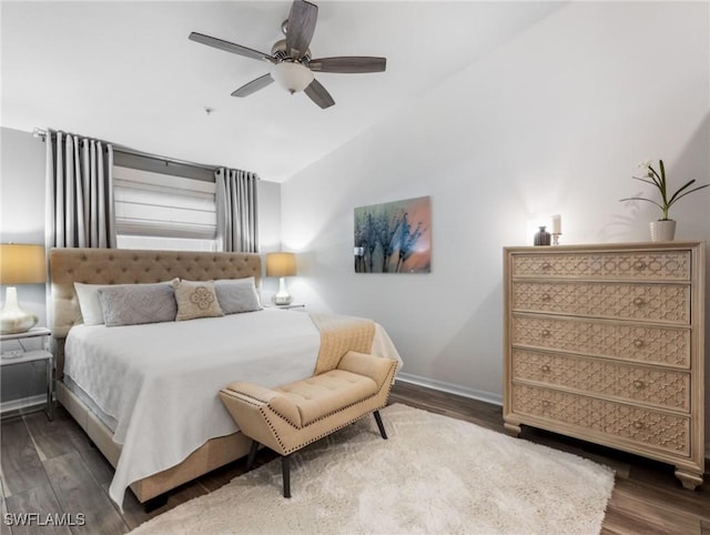 bedroom with baseboards, a ceiling fan, vaulted ceiling, and wood finished floors