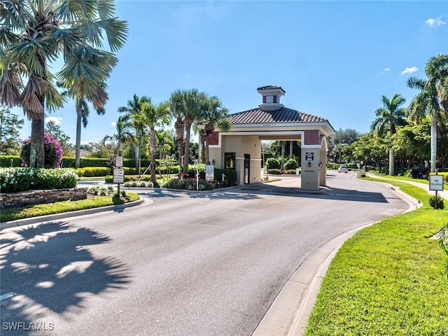 view of road featuring curbs and a gated entry