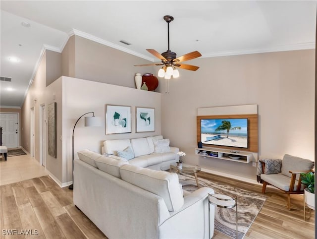 living room with crown molding, ceiling fan, and light hardwood / wood-style floors