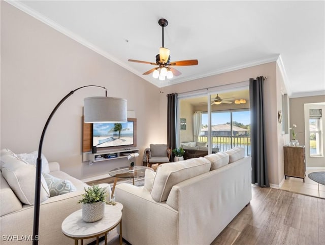 living area featuring baseboards, wood finished floors, a ceiling fan, and crown molding