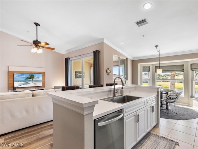 kitchen with sink, white cabinets, a center island with sink, decorative light fixtures, and stainless steel dishwasher