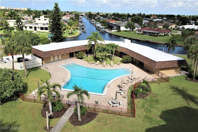 view of swimming pool with a water view, a yard, and a patio area