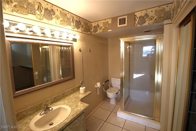 bathroom featuring an enclosed shower, vanity, tile patterned floors, and toilet