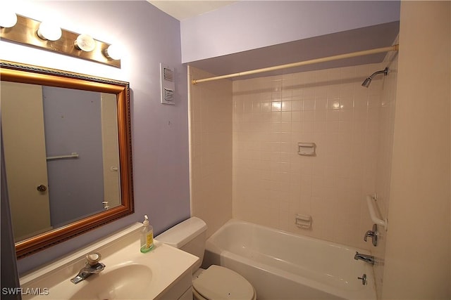 full bathroom with tiled shower / bath combo, vanity, and toilet