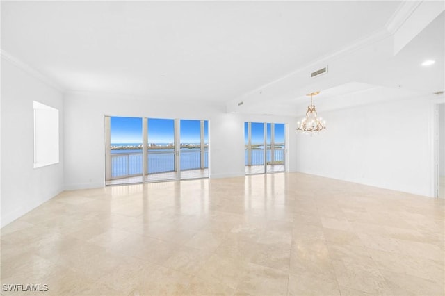 empty room with a water view, crown molding, and an inviting chandelier