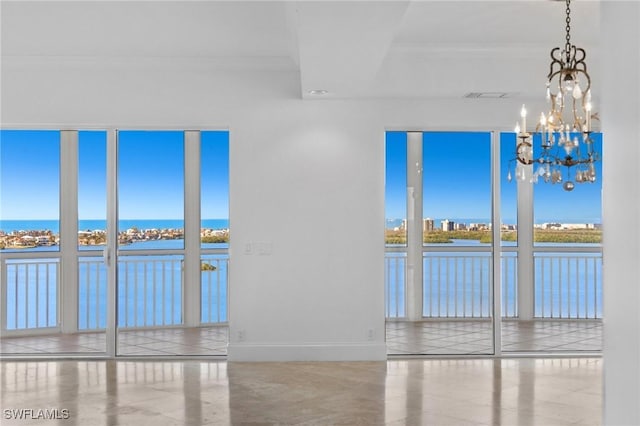 unfurnished room with crown molding and a water view