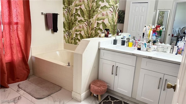 bathroom featuring vanity and a relaxing tiled tub