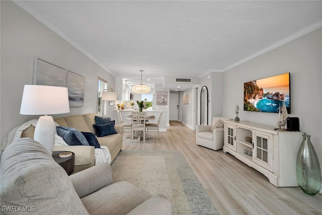 living room with crown molding and light hardwood / wood-style flooring