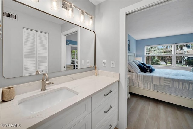 bathroom with vanity and hardwood / wood-style flooring