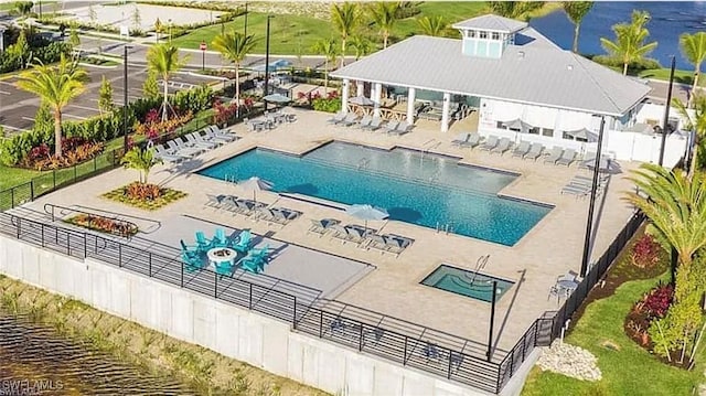 view of pool with a patio area and a water view