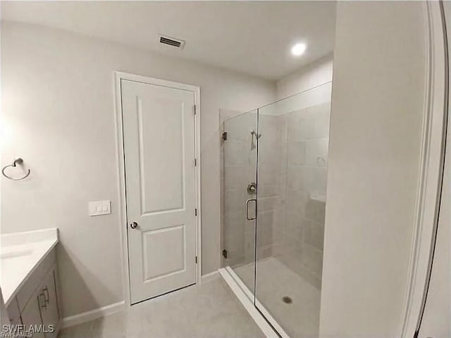 bathroom with vanity and a shower with shower door