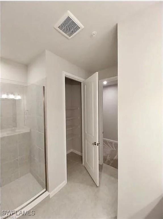 bathroom with tiled shower