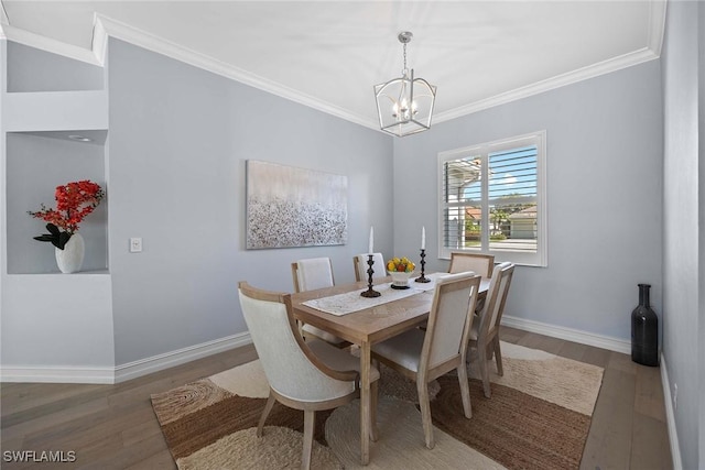 dining room featuring ornamental molding, dark hardwood / wood-style floors, and a chandelier