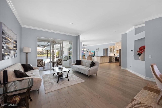 living room featuring crown molding, hardwood / wood-style floors, and a chandelier