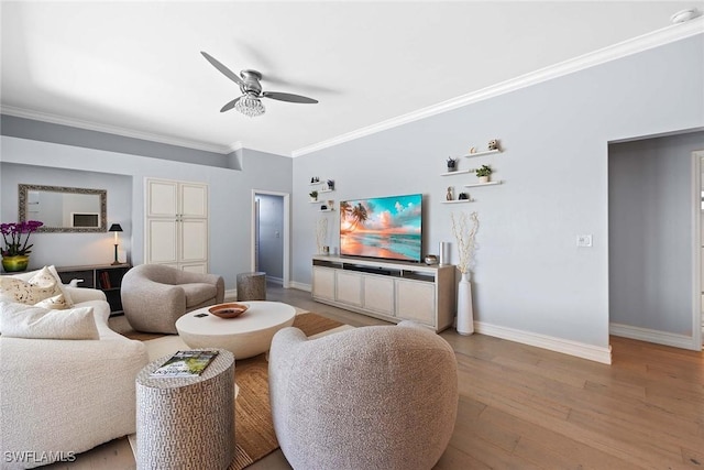 living room featuring hardwood / wood-style flooring, ornamental molding, and ceiling fan