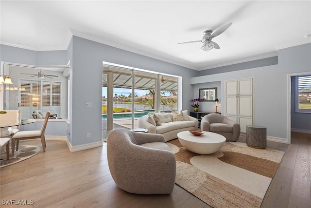 living room with crown molding, light hardwood / wood-style floors, and ceiling fan