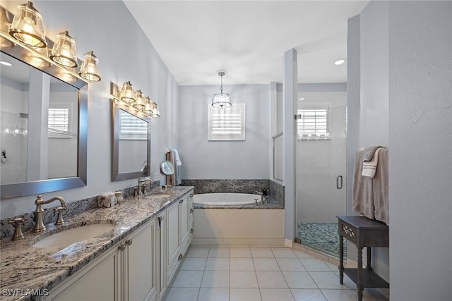 bathroom with vanity, plus walk in shower, and tile patterned flooring