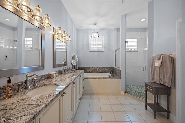 bathroom with tile patterned floors, shower with separate bathtub, and vanity